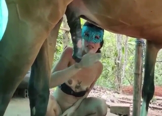 Masked lady is happy to suck that horse dick